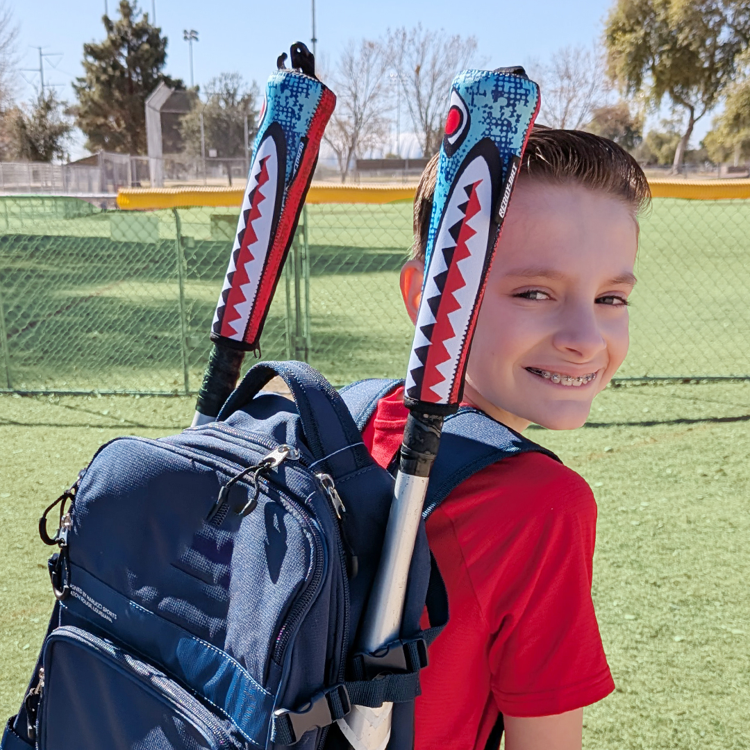 Ready Bat Bomber baseball bat handle cover on a baseball bat sticking out of a backpack in a parking lot