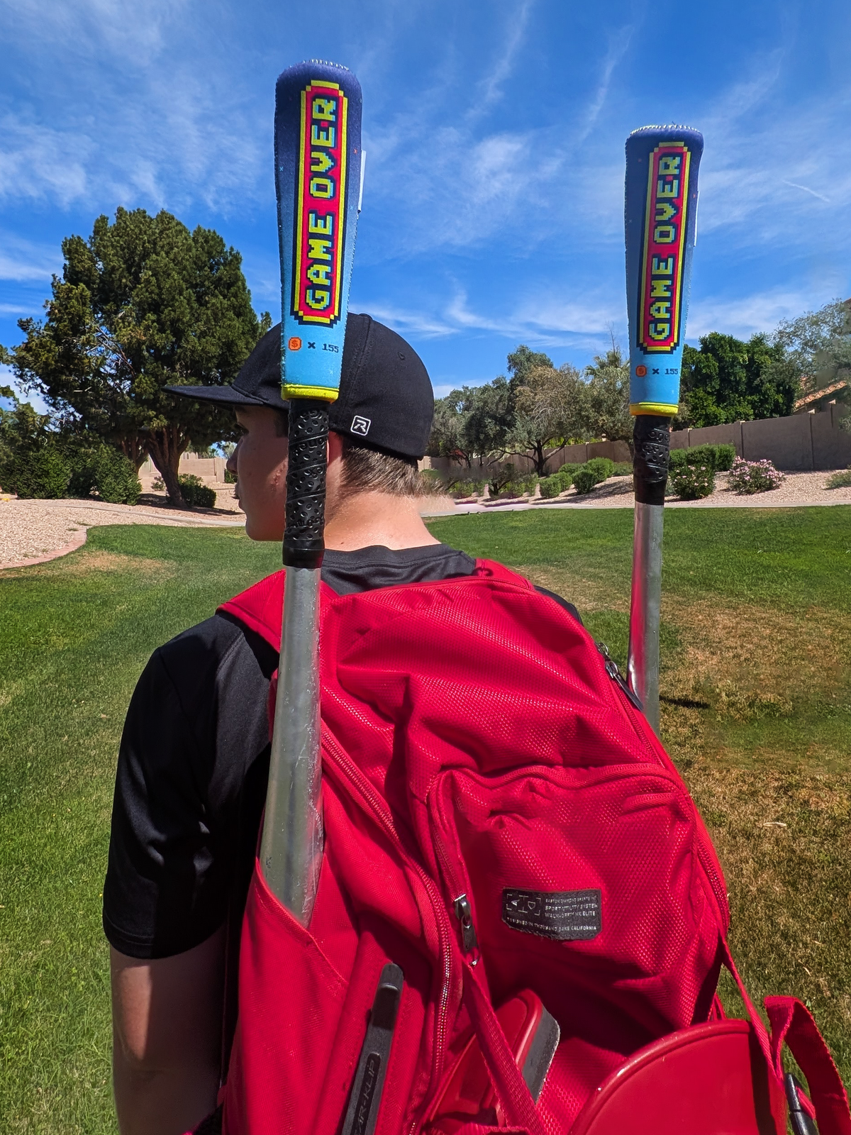 Gamer bat handle cover lifestyle photo showing the retro gaming design at the baseball ballfield