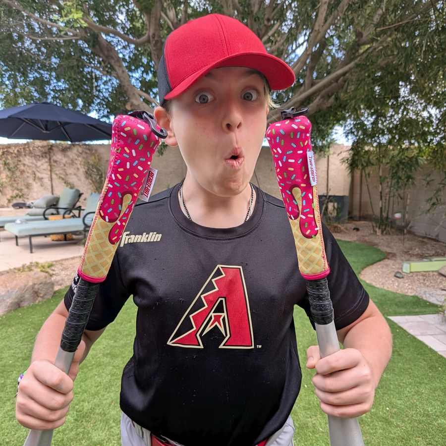 Kid holding two Ice Cream covered bats