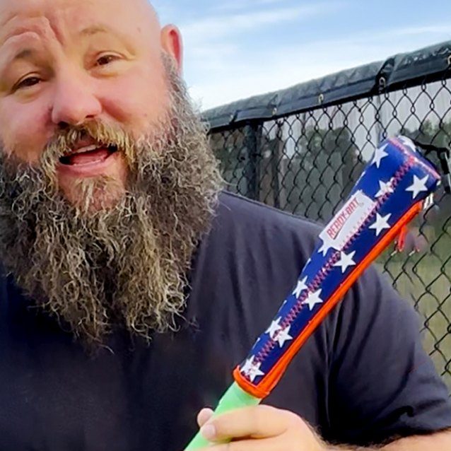 The Dancing Umpire holding an All Stars covered bat